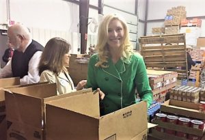 Mrs. Britainy Beshear works to pack boxes of food for the CSFP Program. 